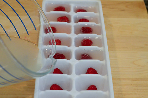 Lemonade being poured into the ice cube tray.