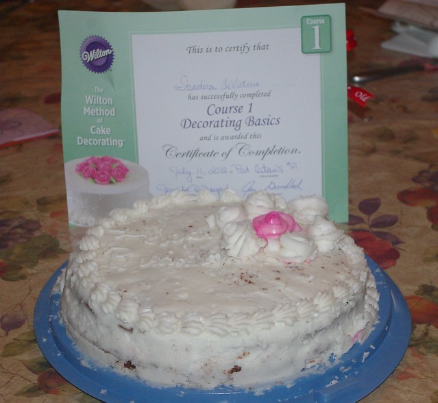 Izzy's first complete cake and her certificate for course 1