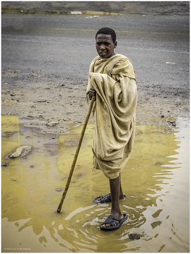 blanket cold dirt ethiopia man mud rainy street water wereta wet amhara