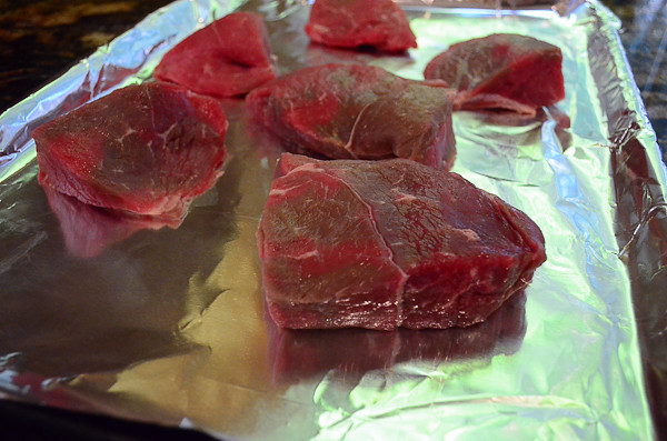 Sirloin steak on a foiled lined baking sheet.