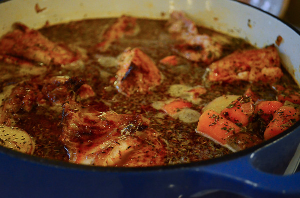 The pan with chicken and herbs added in.