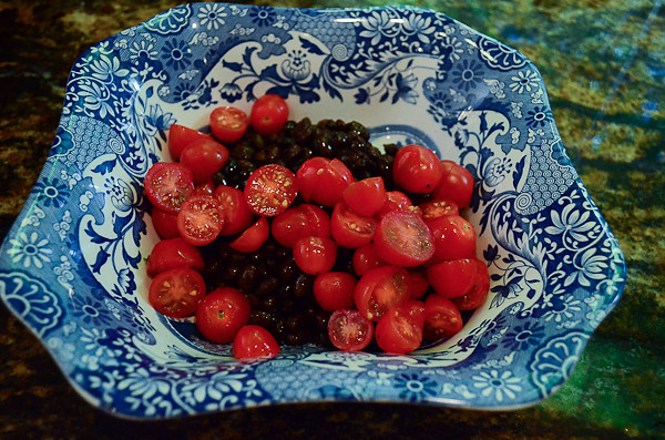 A bowl of black beans and tomatoes.