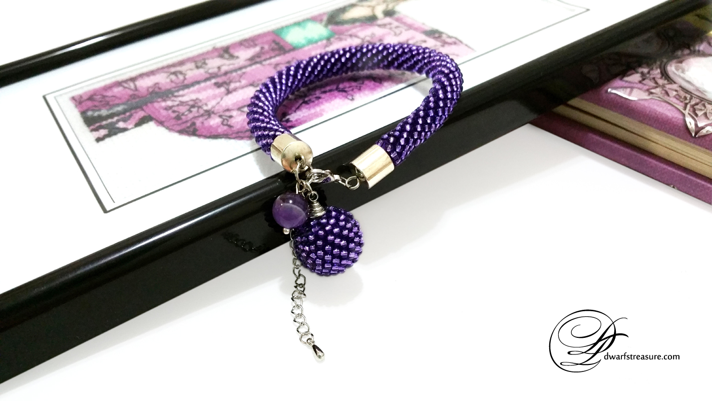 Exclusive ultraviolet beaded crochet rope bracelet with cross stitched picture