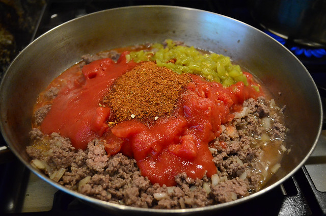 More ingredients are added to the ground beef mixture.