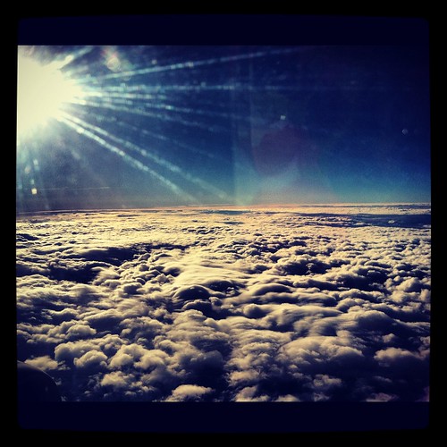 above blue sky sun white clouds plane soft shine view top flight arial