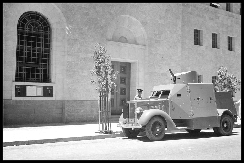 Armoured car guarding entrance to G.P.O. bldg in Jerusalem, Palestine 1939.
