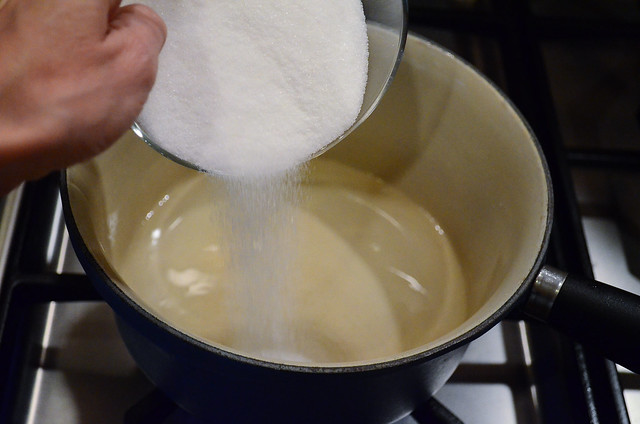 Sugar and water is added to a pan.