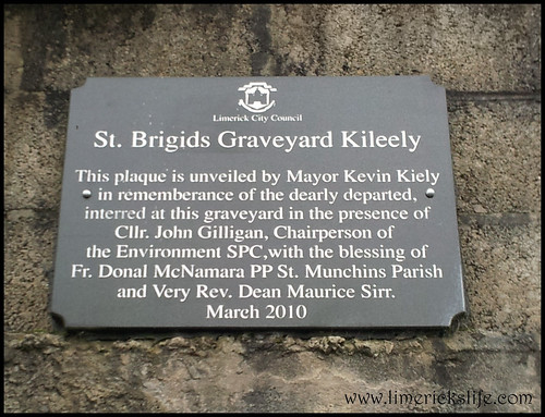 Civic Trust Plaque reads "St Brigids Graveyard Kileely. This plaque is unveiled by Mayor Kevin Kiely in remembrance of the dearly departed, interred at the graveyard in the presence of Cllr. John Gilligan, Chairperson of the Environment SPC, with the blessing of Fr Donal McNamara PP St Munchin's Parish and Very Rev Dean Maurice Sirr. March 2010