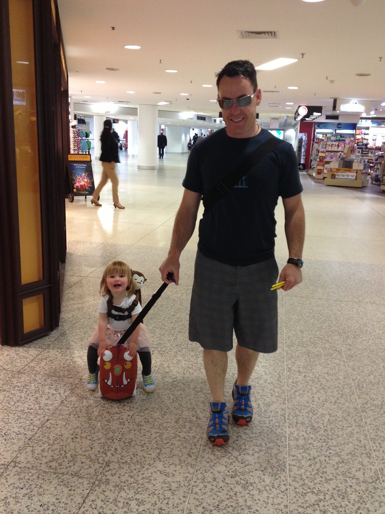 At the airport, riding on trunki