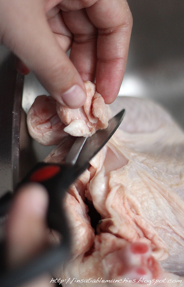 trimming the excess fat off the chicken