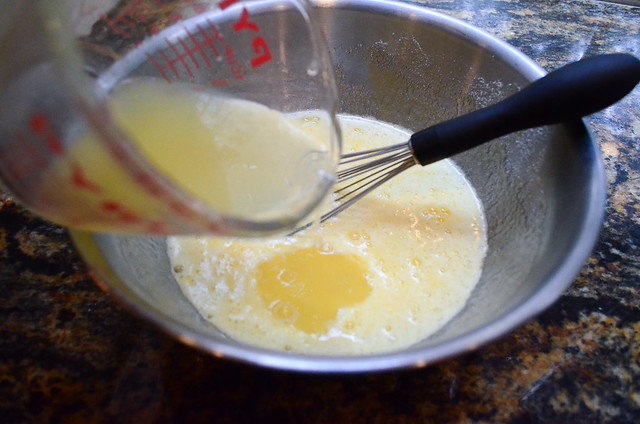 Lemon juice being added into the egg mixture.