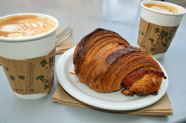 Two coffee and a Ham and Cheese Croissant.
