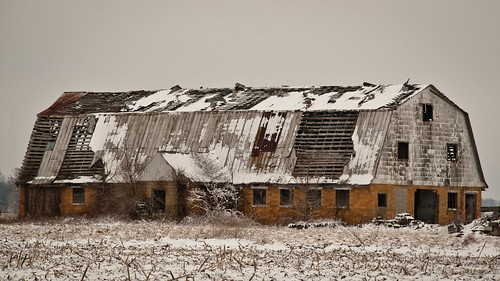 old winter snow abandoned barn rural ruins decay metalroof glazedbrick cornstubble