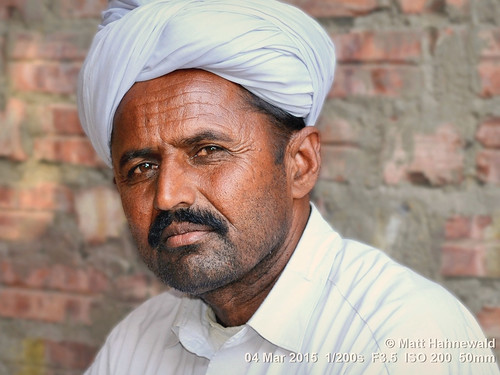 photo primelens portrait cultural character mouth consent emotion male posing pagari turban authentic relationship rugged moustache closeup street color eyes traditional matthahnewaldphotography face facingtheworld horizontal 4x3 head india indian jaisalmer nikond3100 outdoor rajasthan thar travel tribal 50mm oneperson expression headshot nikkorafs50mmf18g lookingcamera fullfaceview