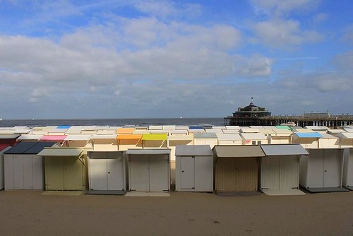 cabins on the beach and the pier in the background