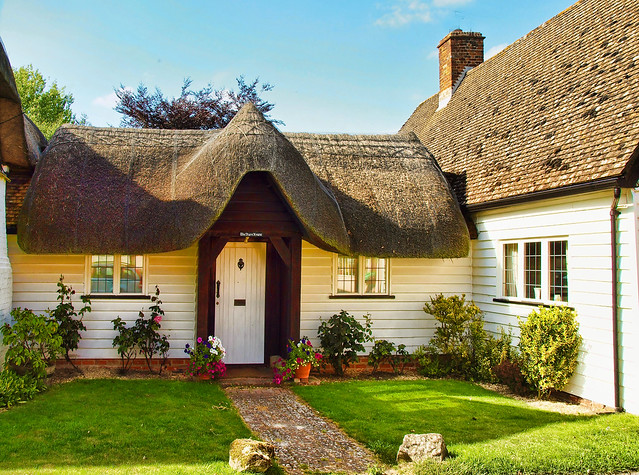 A quaint little thatched building connecting two cottages at Nether ...