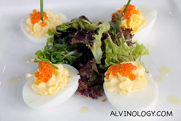 Deviled eggs with ponzu salad topped with ikura