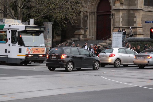 Cars delays trams as the queue through the intersection of Swanston and Flinders Streets