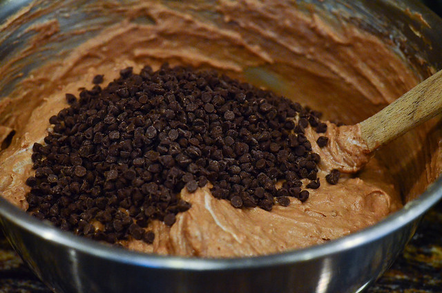 Mini chocolate chips are poured into the mixing bowl.