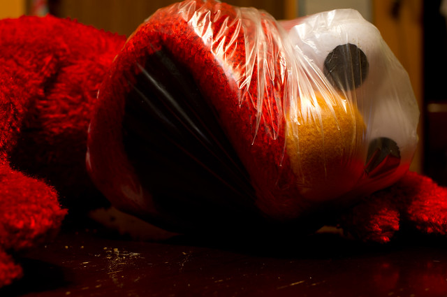 Elmo  plays with a plastic bag