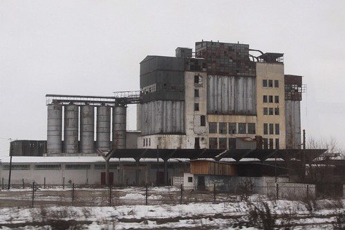Derelict looking grain silo and mill complex at Periş, Romania