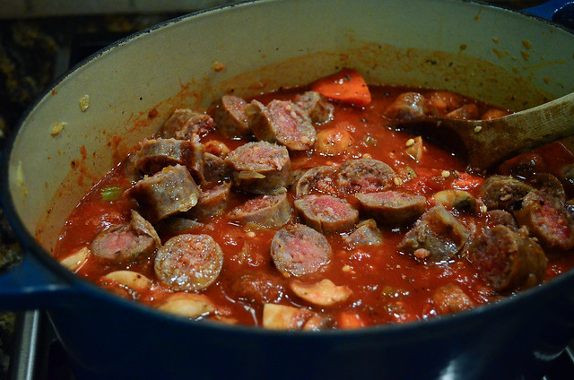 Italian Sausage slices are added to the pot.