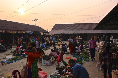 the sun rises over the Muang Sing market. You have to get up early--it runs from 6-8am.