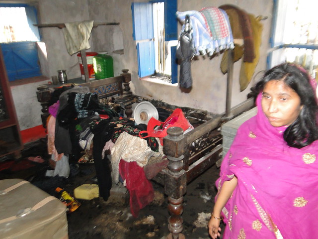 Ruksana Khatoon of village Azizpur showing her burnt and looted house by the mob.