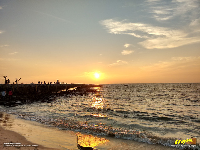 People, boats and the sunset on an evening in Panambur Beach, Mangalore, Mangaluru, Dakshina Kannada, Karnataka, India