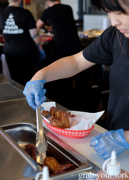 Serving smoked chicken wings at Vic's Meat Market at Sydney Fish Market, Pyrmont
