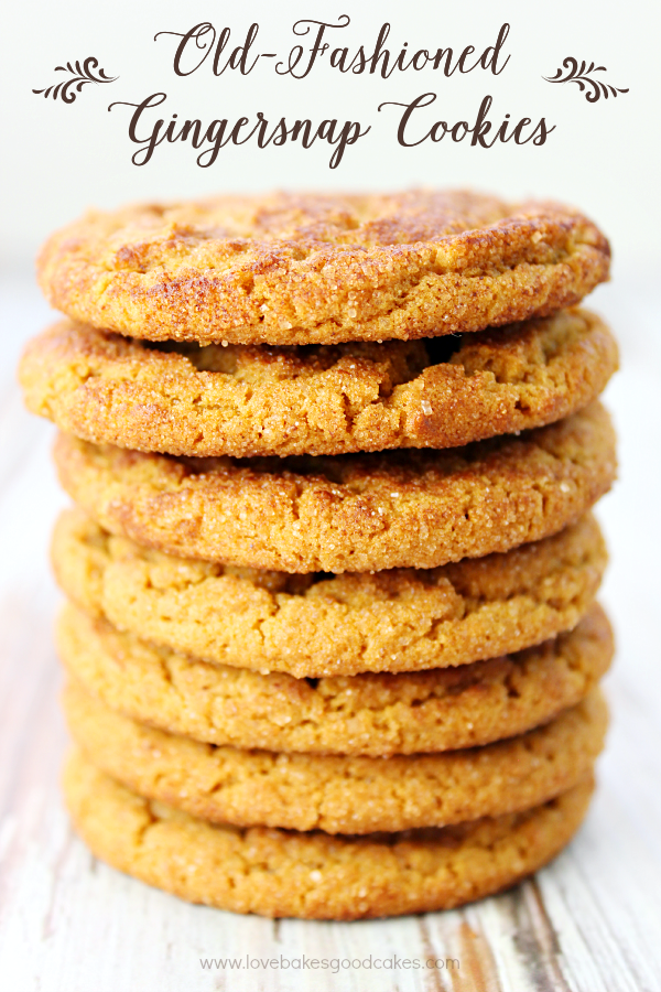 Old-Fashioned Gingersnap Cookies stacked up on a cutting board.