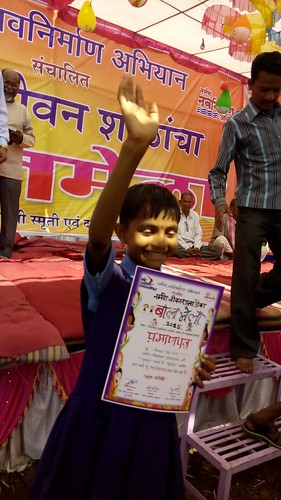 A girl in a happy mood after receiving the certificate for her performance in a play