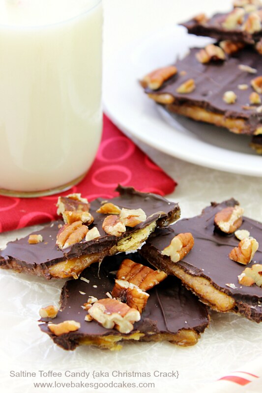 Saltine Toffee Candy pieces on a plate with a glass of milk.