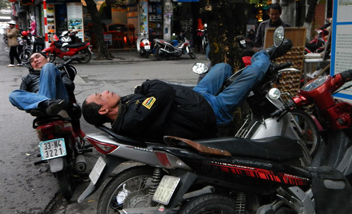 Men Sleeping on his Motorcycles in Hanoi