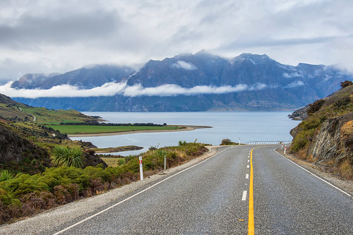 road trip travel blue newzealand summer sky mountain mountains alps tree green tourism nature beautiful grass rural speed forest way landscape outdoors drive highway view background empty horizon country scenic line journey valley transportation otago winding curve asphalt range theneck