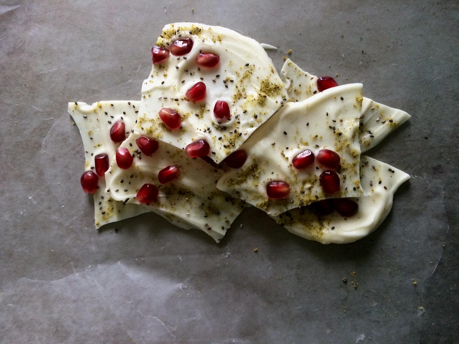 white chocolate pomegranate bark with chia seeds and pistachios