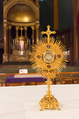 an open or transparent receptacle in which the consecrated Host is exposed for veneration.
