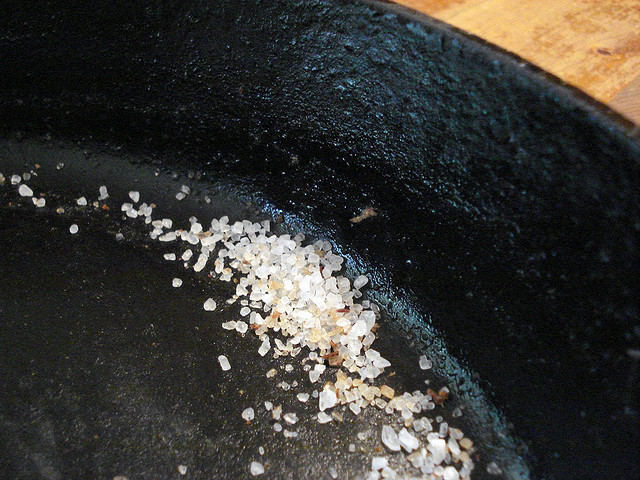 Cleaning a cast iron skillet with coarse sea salt by cbertel on flickr
