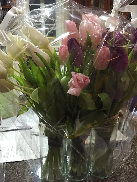 thirty tulips in three glass vases