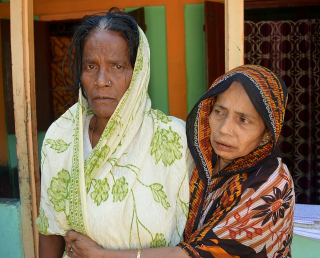 Syed Sarif Uddin Khan's mother Jubeida Khanam (left) is being consoled by a relative at their home at Bosla in Karimganj district. (Photo credit: Biki Saha)