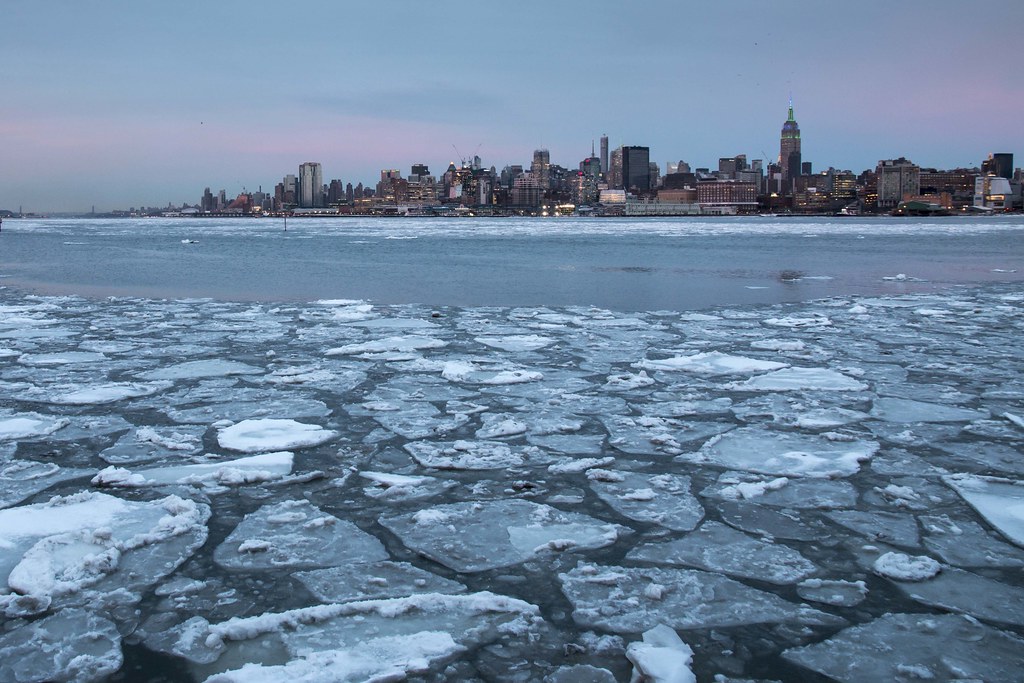Empire State Building and ice floes on the Hudson River, New York
