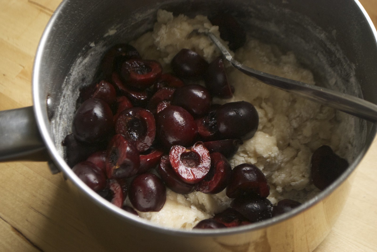 stirring cherries into muffin batter