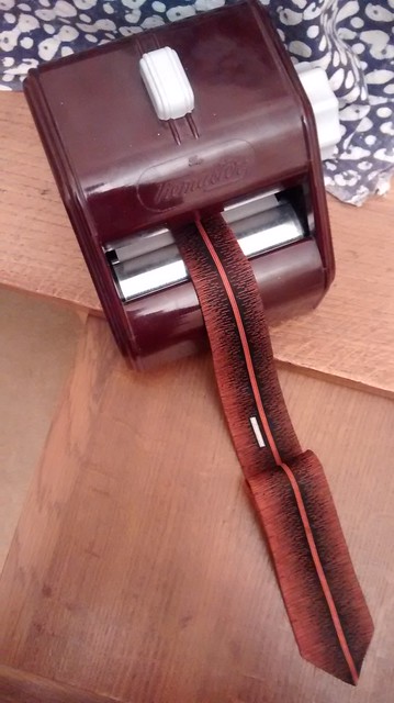 A Corby Tiemaster tie press and vintage tie