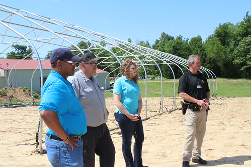 NRCS staff discuss soil health efforts with Hopkins County jailer Joe Blue, right, and Deputy Jailer Billy Thomas and the jail’s gardener. NRCS photo by Christy Morgan.