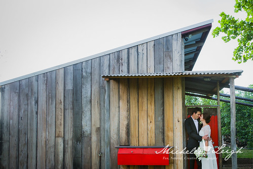 Bride and Groom in front of a shed.