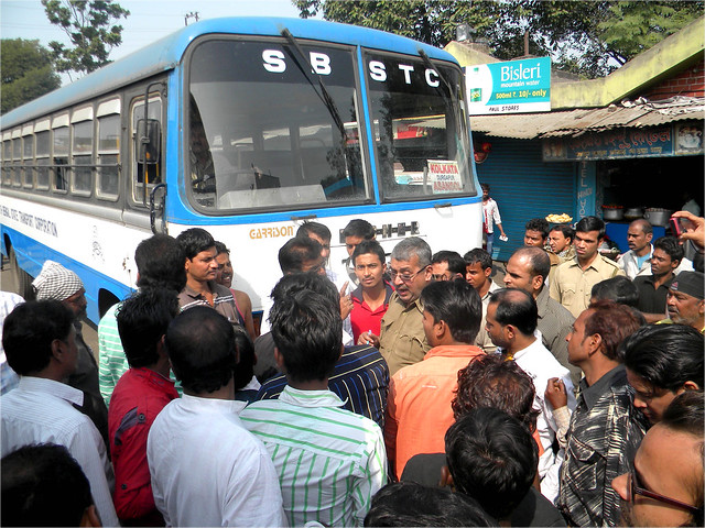 Local people of Asansole shows agitation at Asansole Bus Stand against State run Bus driver and conductor in presence of Police officer of Asansole South police station on 24 November, 2014