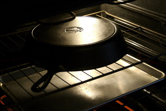 Seasoning a cast iron pan in the oven by Joelle van Dyne