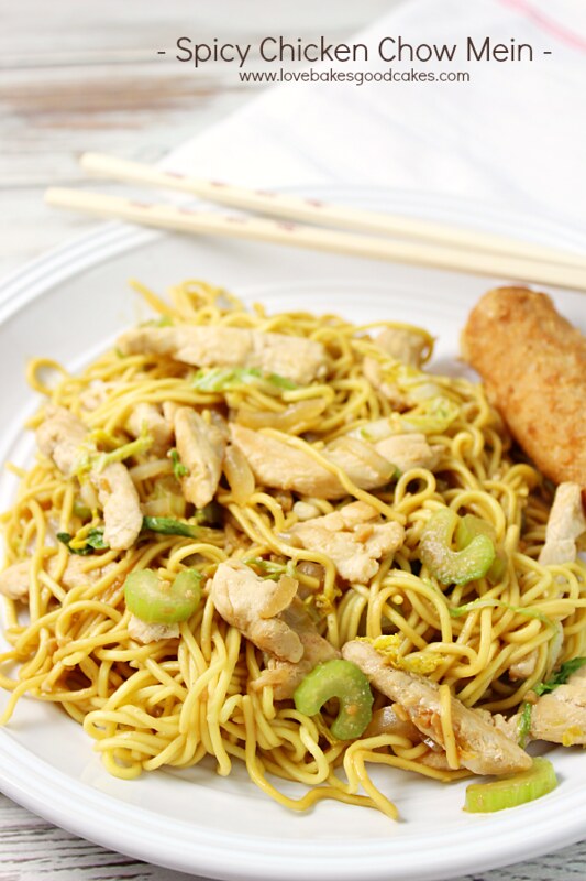 Spicy Chicken Chow Mein in a bowl with chopsticks and an egg roll.