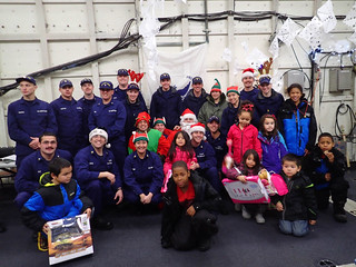 Crew members from the Coast Guard Cutter Alex Haley and Santa Claus join children from Akutan, Alaska, during a visit to the village Dec. 23, 2014. The crew of the CGC Alex Haley delivered Santa along with gifts and charitable donations to the village. (U.S. Coast Guard photo submitted by CGC Alex Haley)