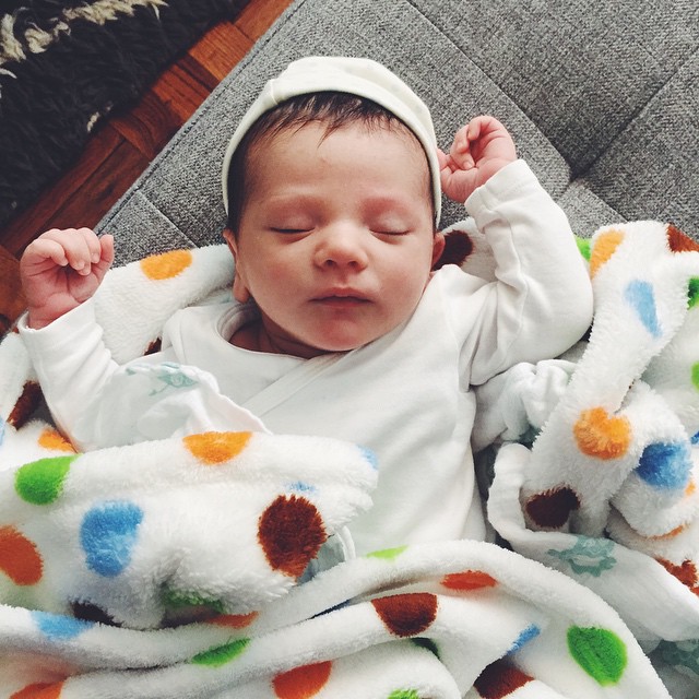 Happy three weeks, little guy! We're excited to get to know you better. So far, your favorite things are eating, pooping, and sleeping. Currently, you're into this super soft blanket - and throwing your arms up in the air like you're celebrating.